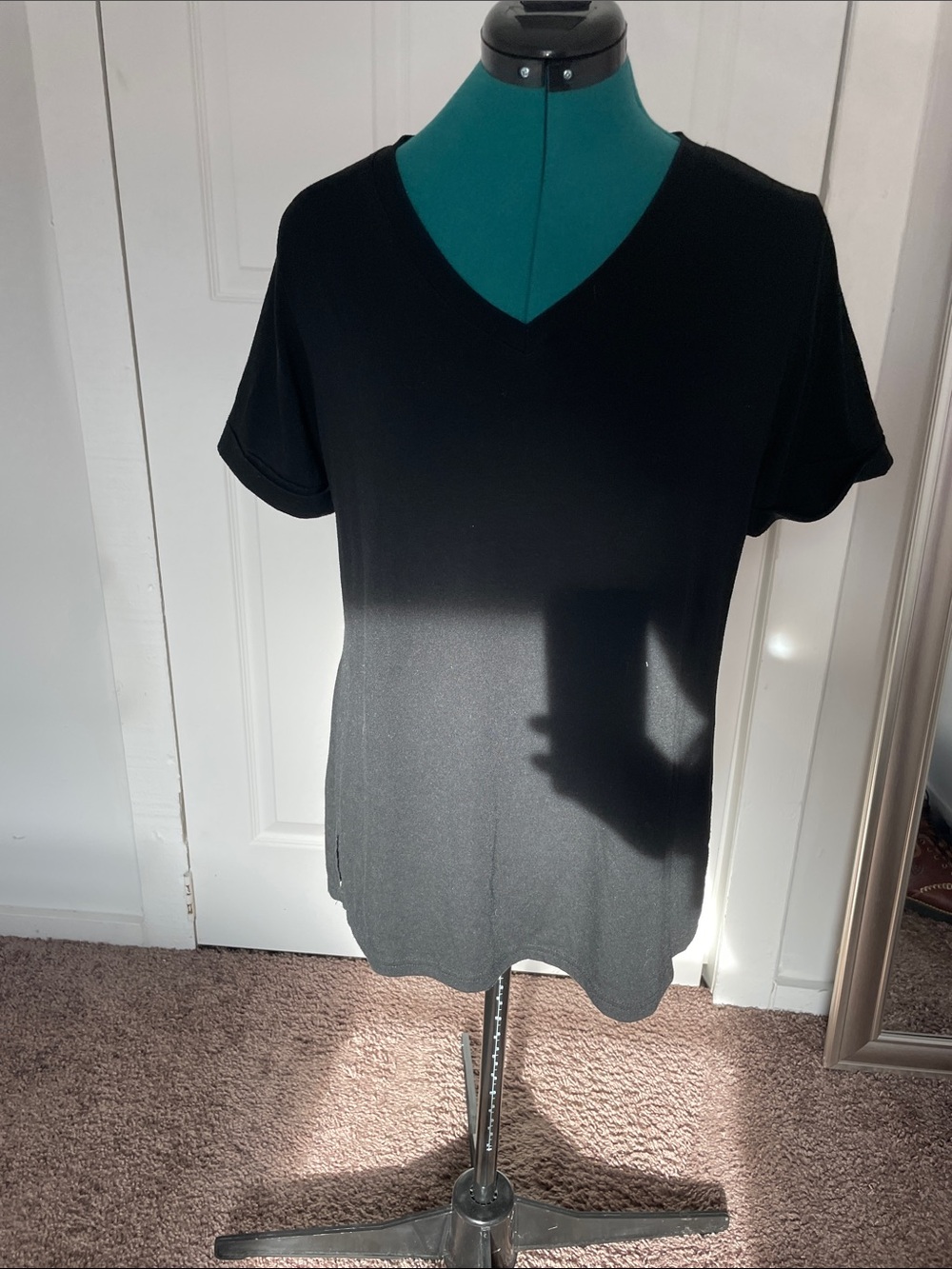 Women’s long black top.